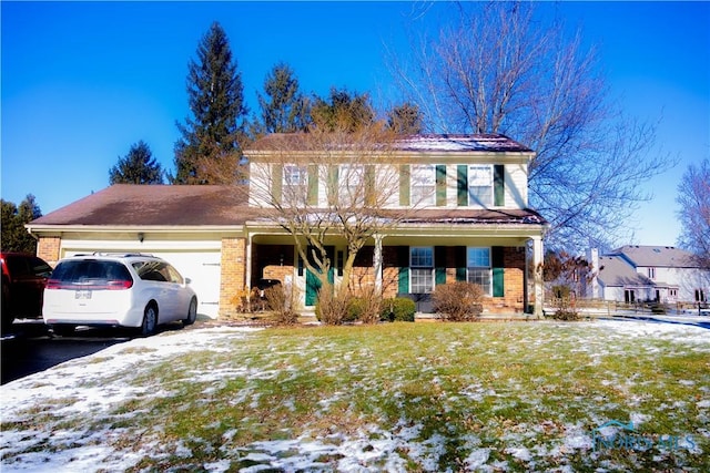 view of front of home with a garage and a yard