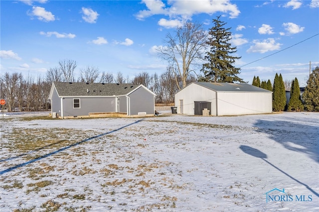 yard layered in snow with an outdoor structure