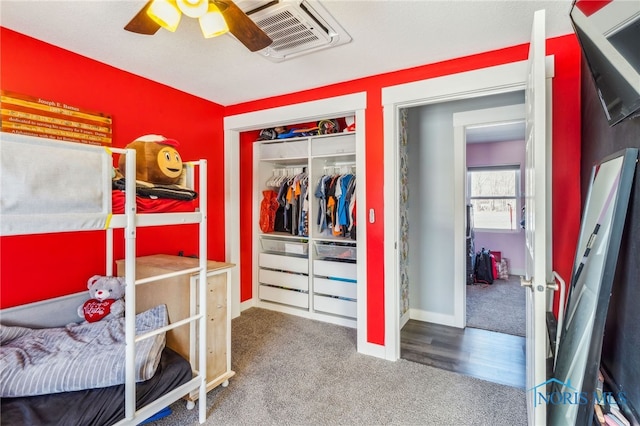 bedroom with ceiling fan, carpet, and a closet