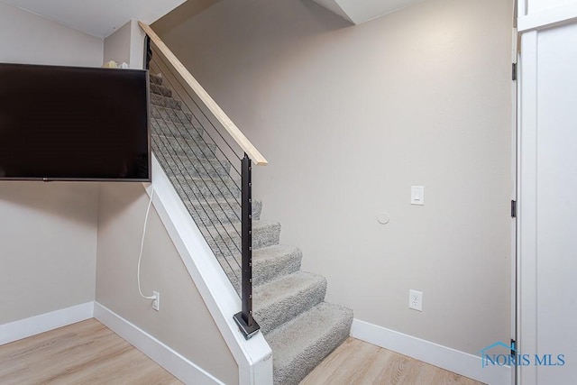 stairway featuring wood-type flooring