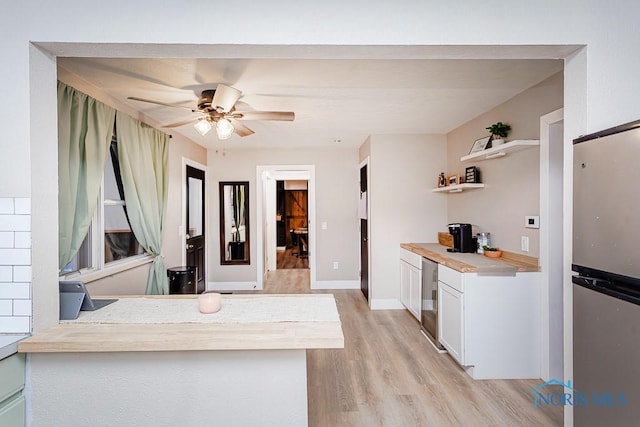 kitchen featuring white cabinetry, light hardwood / wood-style floors, stainless steel fridge, ceiling fan, and beverage cooler