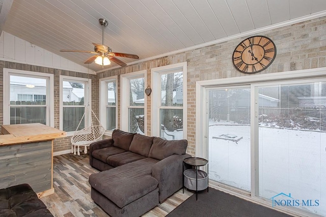 sunroom / solarium featuring ceiling fan, lofted ceiling, and wood ceiling