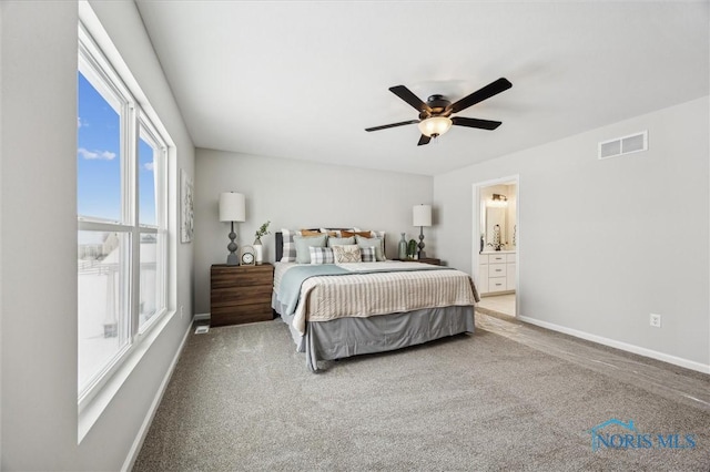 carpeted bedroom with ceiling fan and ensuite bathroom