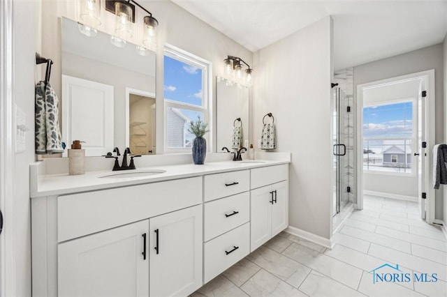 bathroom featuring walk in shower, vanity, and a wealth of natural light