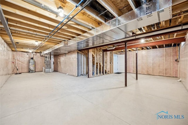 basement featuring heating unit and water heater