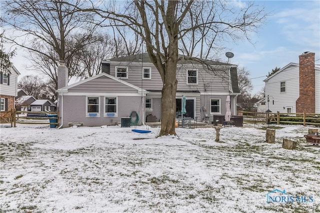 snow covered property featuring central air condition unit