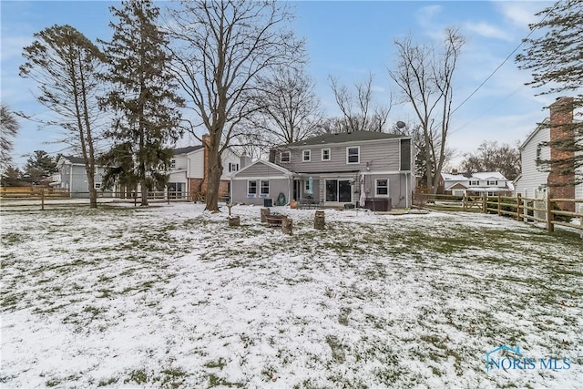 view of snow covered rear of property