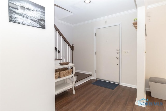 entryway featuring ornamental molding and dark hardwood / wood-style floors