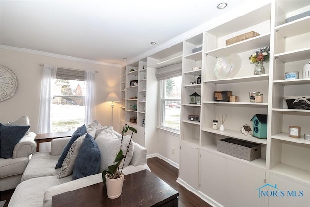 living room featuring crown molding, a healthy amount of sunlight, and dark hardwood / wood-style floors