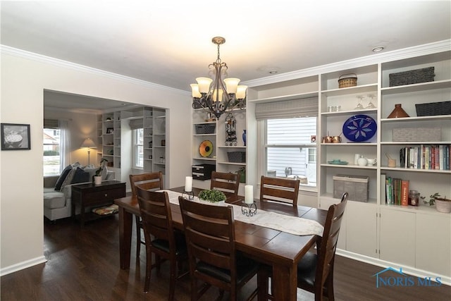 dining area with crown molding, dark hardwood / wood-style flooring, and an inviting chandelier