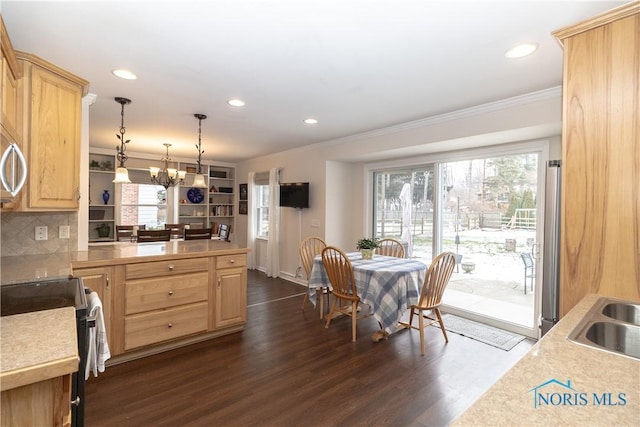 kitchen with pendant lighting, stainless steel refrigerator, black electric range oven, a healthy amount of sunlight, and light brown cabinetry