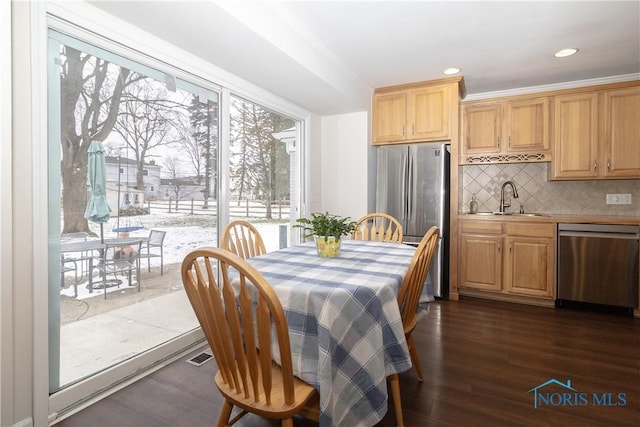 dining room featuring dark wood-type flooring and sink