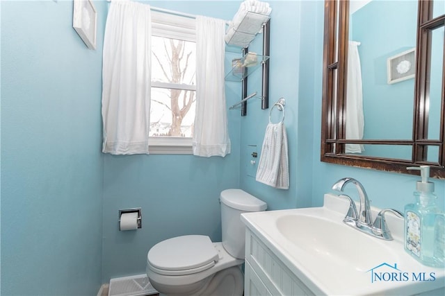 bathroom with toilet and vanity