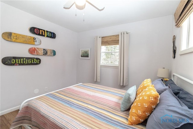 bedroom with ceiling fan and hardwood / wood-style floors