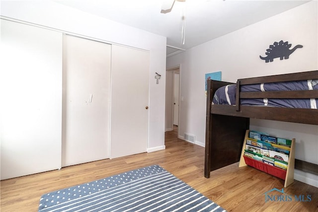 bedroom with hardwood / wood-style floors and a closet