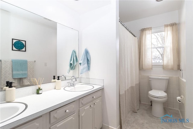 bathroom featuring tile patterned floors, toilet, vanity, and walk in shower