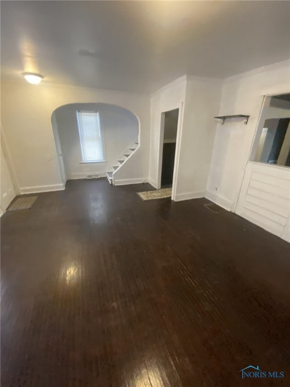 unfurnished living room with dark wood-type flooring