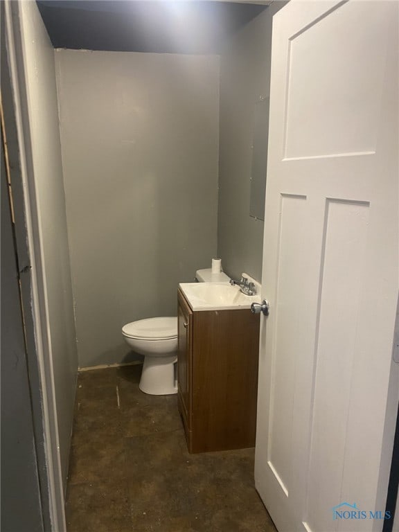 bathroom featuring toilet and vanity