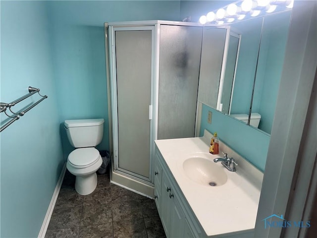 bathroom with walk in shower, vanity, and toilet