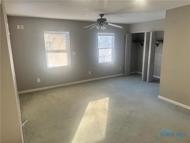 unfurnished bedroom with ceiling fan, carpet, and a closet