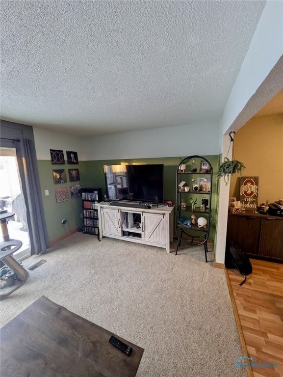 living room featuring carpet floors and a textured ceiling