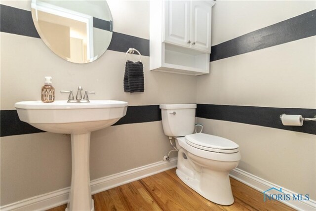 bathroom featuring toilet and hardwood / wood-style flooring