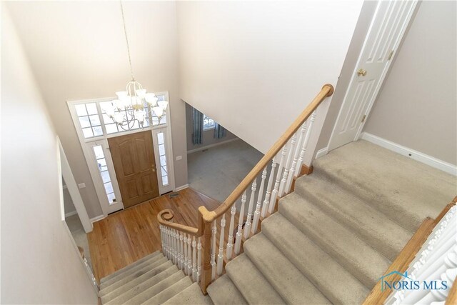 entrance foyer featuring a high ceiling and an inviting chandelier