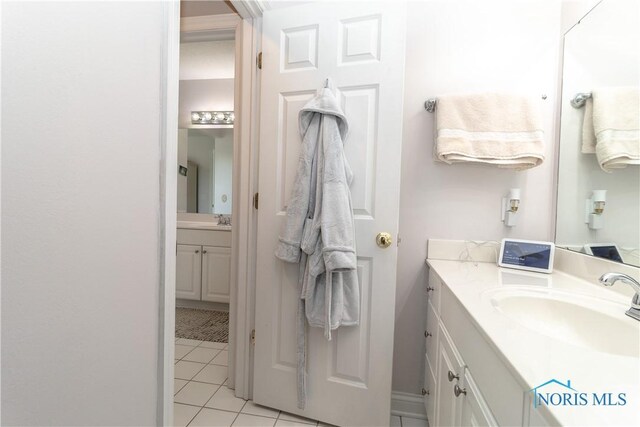 bathroom with tile patterned flooring and vanity