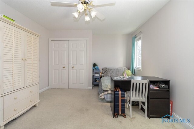 carpeted office space with ceiling fan