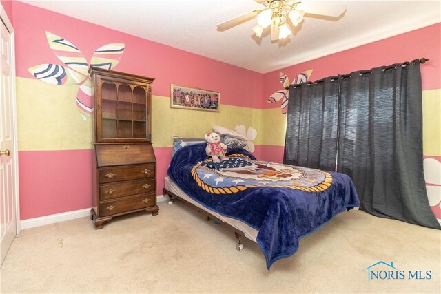 bedroom with ceiling fan and light carpet