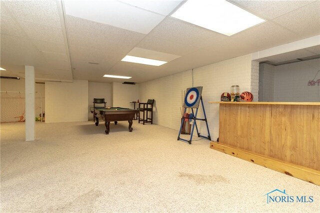 playroom with brick wall, pool table, a paneled ceiling, and bar area