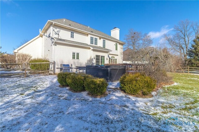 snow covered house with a hot tub