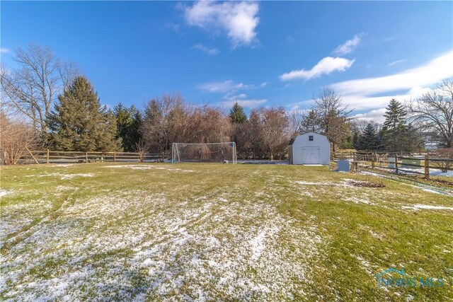 view of yard featuring a rural view and a storage unit