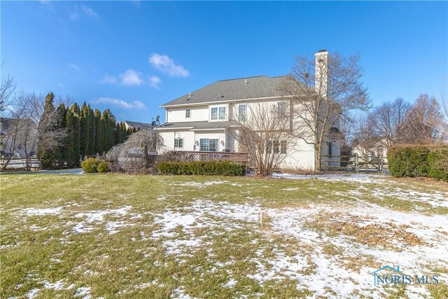 snow covered property with a yard