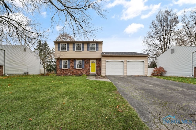 view of front of house with a front yard and a garage