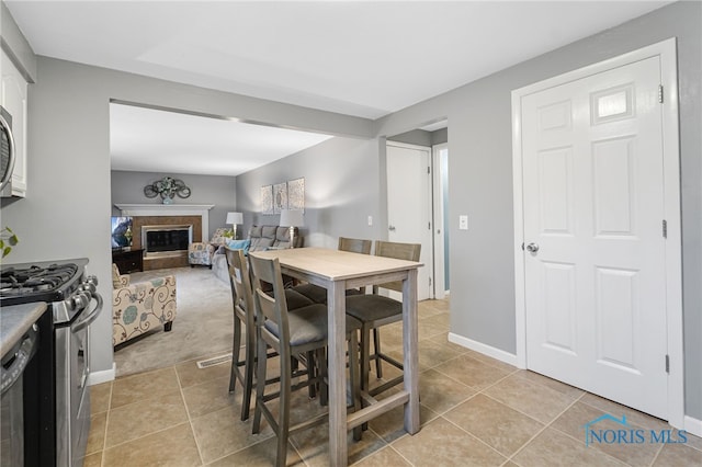 dining space featuring light tile patterned flooring