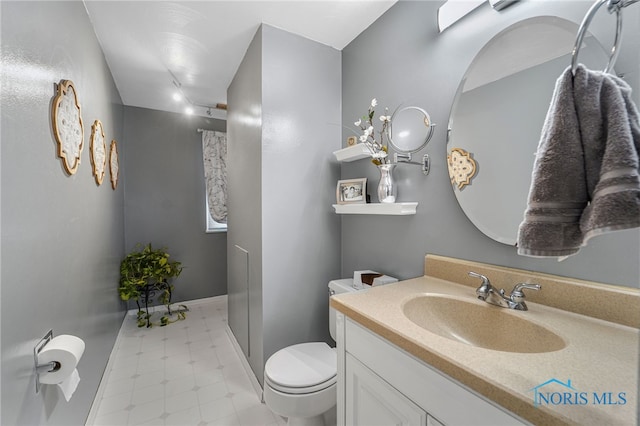 bathroom with vanity and toilet