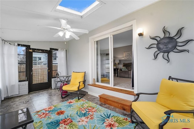 sitting room with ceiling fan, a skylight, and a wealth of natural light