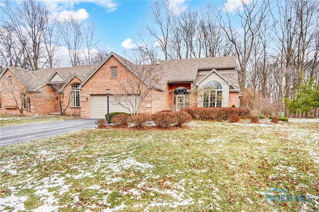 view of front of home with a garage and a front yard