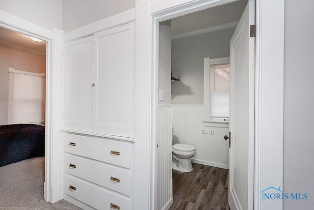 bathroom featuring toilet and wood-type flooring