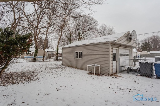 exterior space with a garage and an outdoor structure