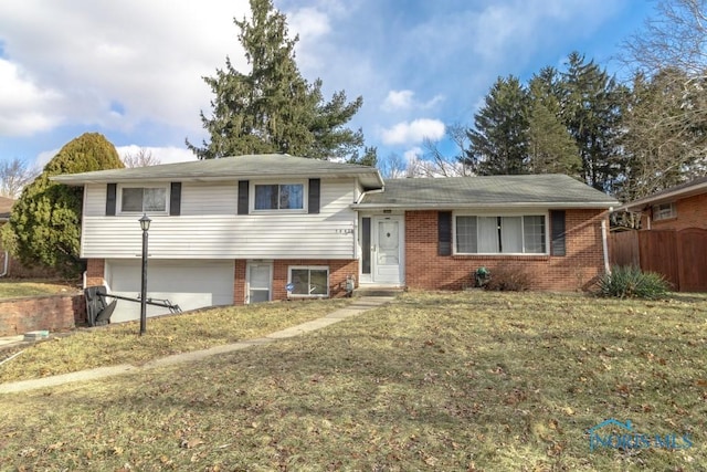 tri-level home with a front yard and a garage