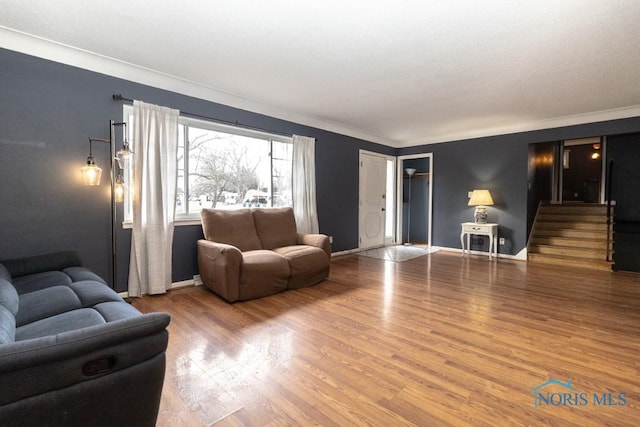 living room with ornamental molding and hardwood / wood-style flooring