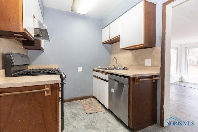 kitchen featuring decorative backsplash, white cabinets, stainless steel dishwasher, black gas stove, and sink