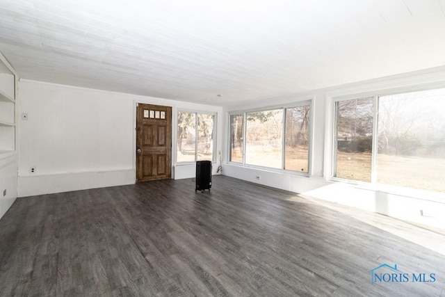 unfurnished living room with dark wood-type flooring