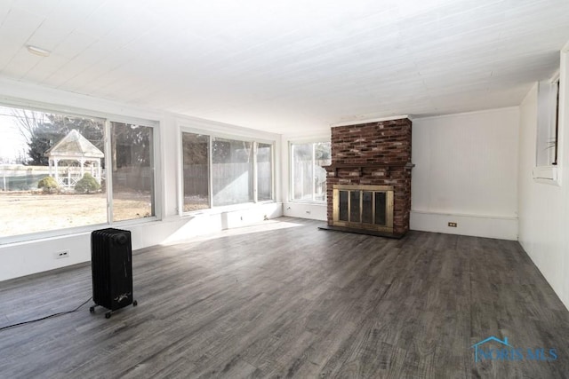 unfurnished living room with dark hardwood / wood-style floors and a fireplace