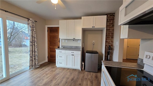 kitchen featuring white cabinetry, white electric stove, light hardwood / wood-style floors, and ceiling fan