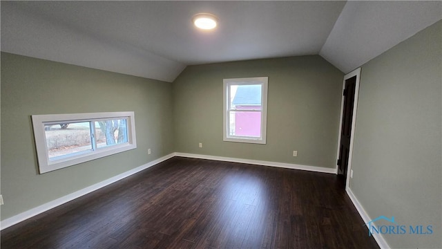 bonus room featuring vaulted ceiling and dark hardwood / wood-style floors