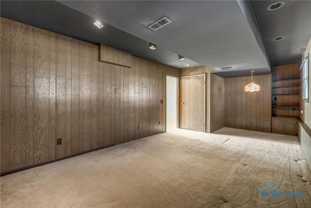 basement with light colored carpet and wooden walls