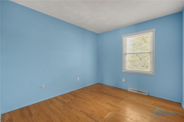 spare room featuring light hardwood / wood-style flooring